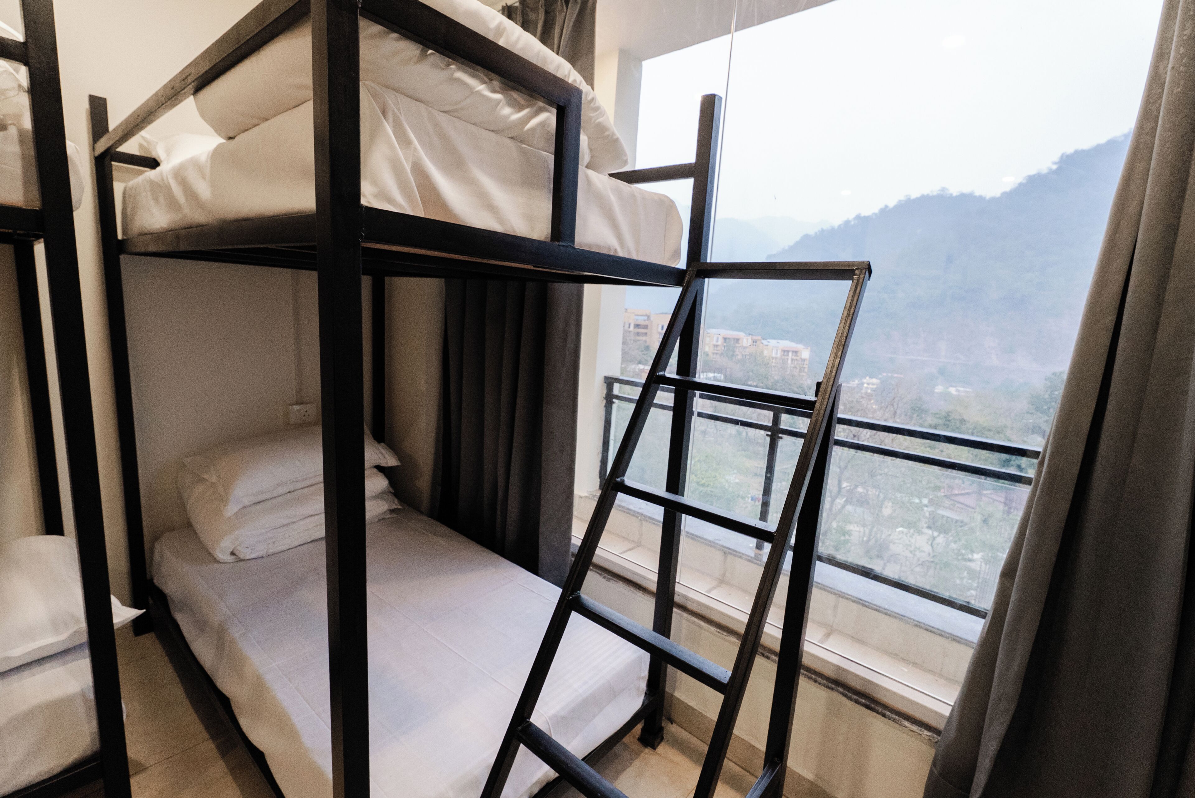 A bunk bed room with a view of mountains.