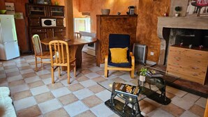 Una sala de estar acogedora con chimenea, muebles de madera y suelo de baldosas.