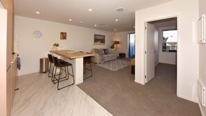 A modern apartment with a kitchen, dining area, and living room. - Chic and Comfy 1 Bedroom in Manchester Street (Christchurch)