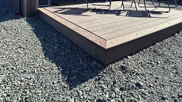 A modern building with large windows, a deck with two lounge chairs, and a gravel ground. - A secluded and tranquil cabin ideal for exploring Lewis and Harris (Isle of Lewis)