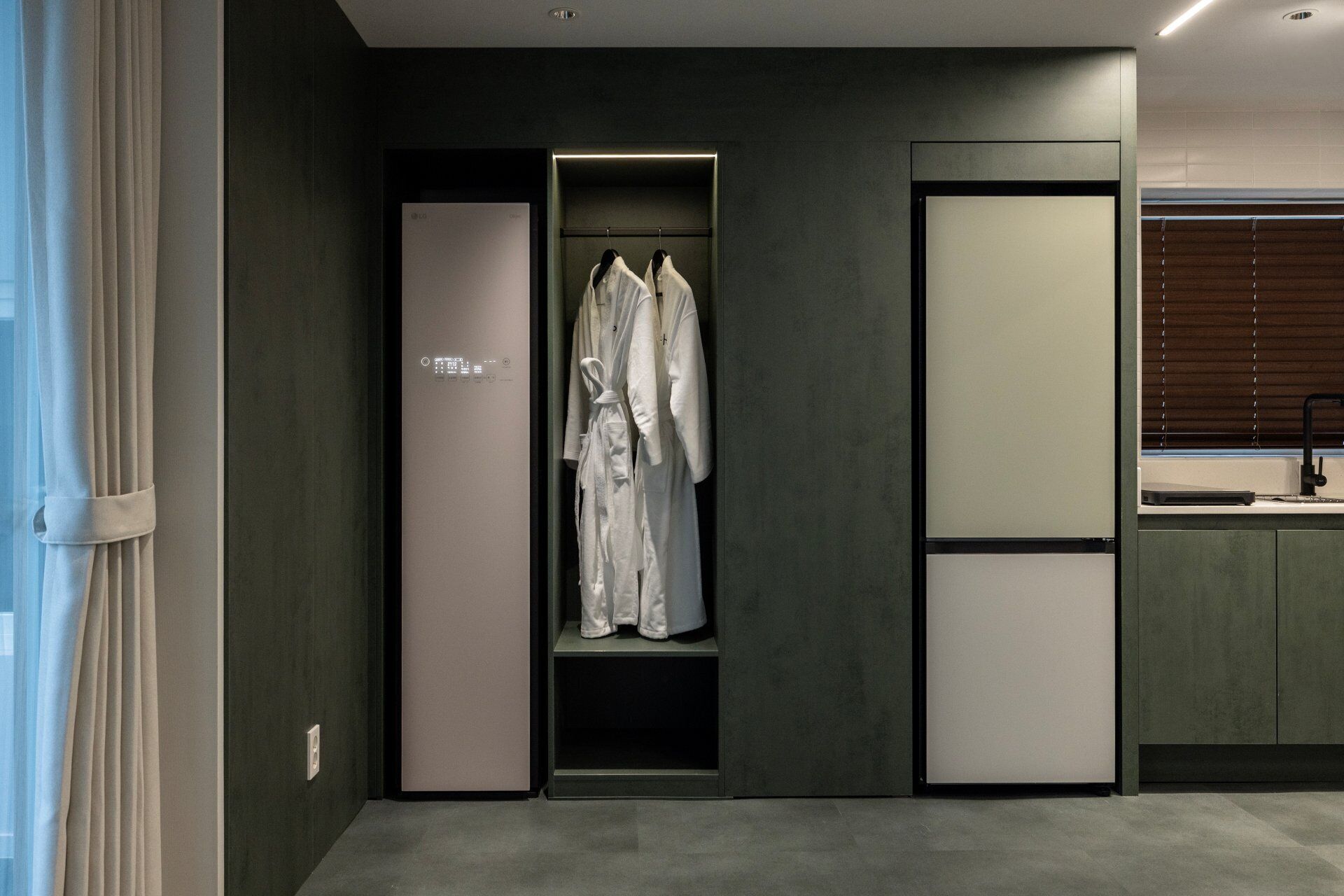 A modern bathroom with a built-in shower, a towel rack, and a mirror.