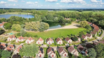A residential area with houses, a lake, and a golf course.