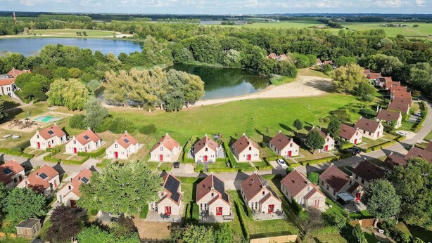 Un quartier résidentiel avec des maisons, un lac et un terrain de golf.