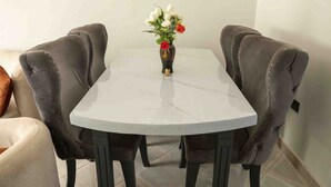 A round table with a white marble top, surrounded by four dark upholstered chairs. - Vo Homes, Modern Kisasi, Kulambiro kyanja Retreat  Quiet, Secure, WiFi Near City (KAMPALA)