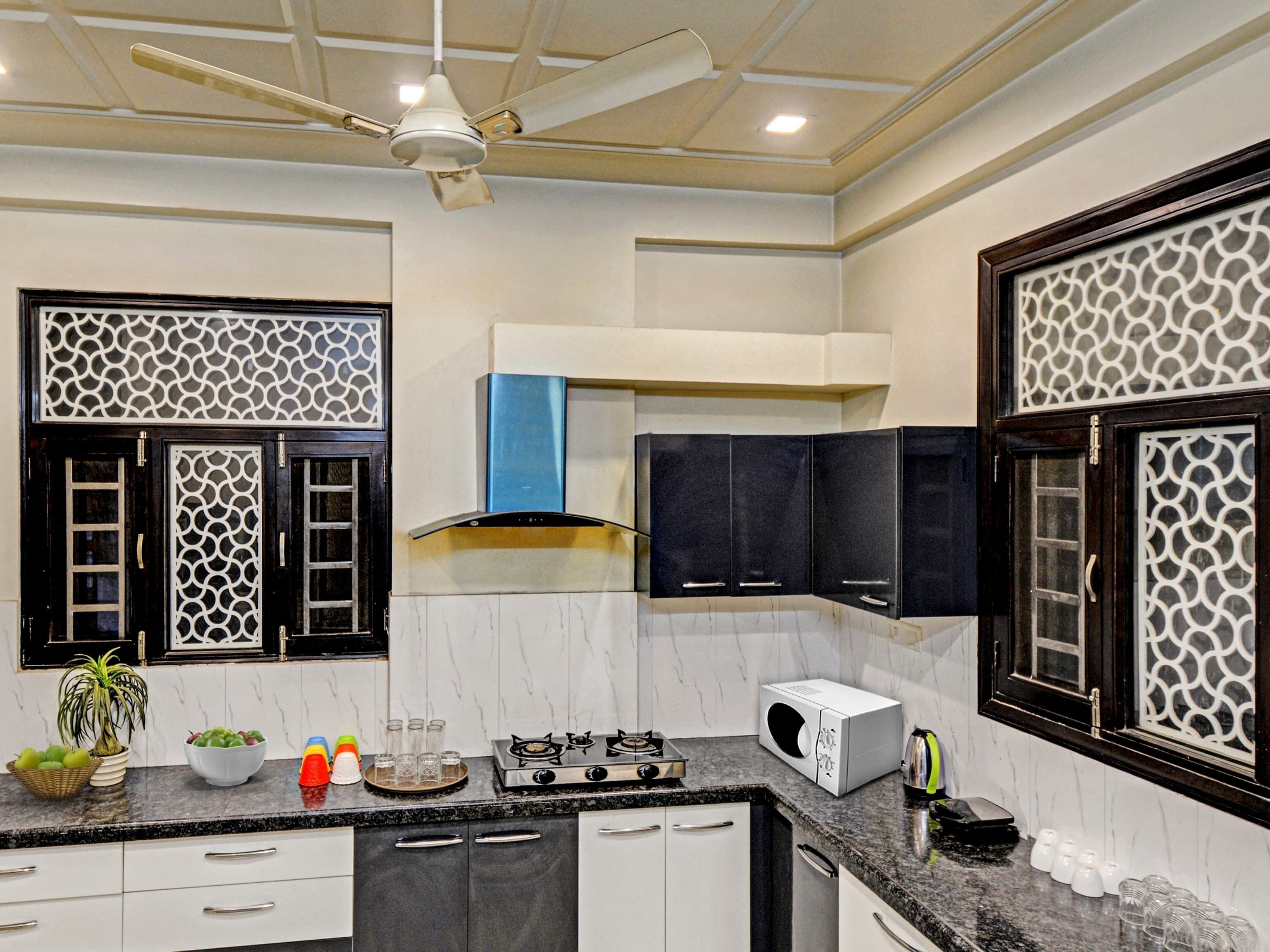 A modern kitchen with a gas stove, microwave, and cabinets.