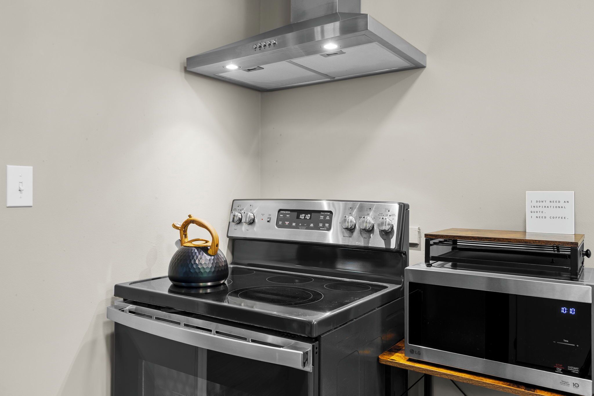 A kitchen with a stainless steel stove, oven, and microwave.