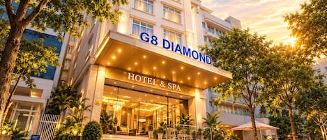 A hotel entrance with a sign reading 'G8 Diamond Hotel & Spa' and a staircase leading to the lobby.