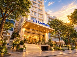 A hotel entrance with a sign reading 'G8 Diamond Hotel & Spa' and a staircase leading to the lobby.