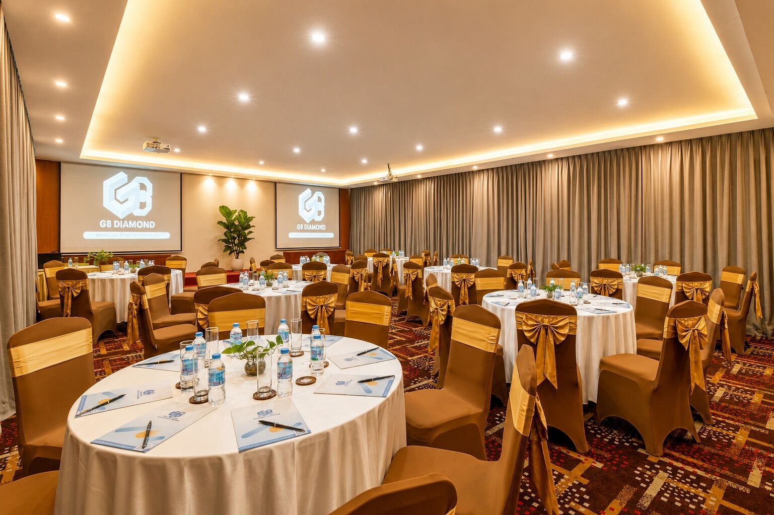A conference room with multiple round tables, each with chairs and table settings, including water bottles and documents.