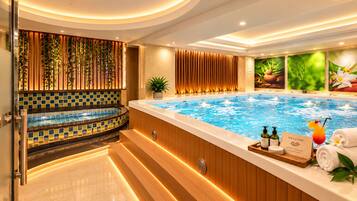 A spa area with a hot tub, wooden paneling, a tiled wall, and a welcome sign.