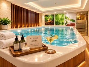 A hotel reception area with a pool, a welcome sign, and amenities like body wash and shampoo. - G8 Diamond Hotel Saigon (Ho Chi Minh City)