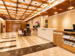 A hotel reception area with a reception desk, a VIP room, and a dining area with a table and chairs. - G8 Diamond Hotel Saigon (Ho Chi Minh City)