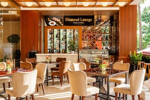A restaurant named 'Diamond Lounge' with a bar area, seating arrangements, and a view of the outdoors.