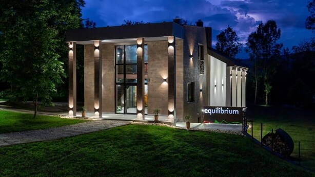 A modern building with a glass facade, columns, and a sign reading 'equilibrium.' - Equilibrium Villa Relais Plitvice (Rakovica)