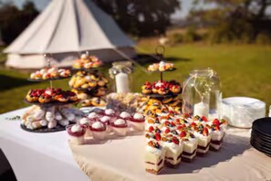 A table with various desserts and a tent in the background. - Group Stay ~ Sauna ~ Farm ~ Quad Rides ~ BBQ (Čmelíny)