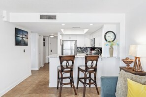 Interior - Enjoy stunning ocean views from the balcony, living room, dining area, and kitchen. This 2BR condo features a heated beachfront pool, fitness room, king beds in both bedrooms, and comfortably sleeps 4 in beautiful Daytona Shores. (Daytona Shores)