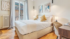 A bedroom with a bed, a desk, and a view of the outside. - "Airbnb Luxe" Gorgeous + 3 Bedroom Near The Duomo (Milano)