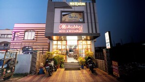 A hotel named 'Mahabhoj' with a signboard, entrance, and potted plants. - Mahabhoj Hotel & Restaurant (Mandarmani)