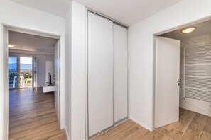 A modern interior with a sliding door, a view of the outdoors, and a wooden floor. - Altiora Prestige Residence 201 (Gradac)