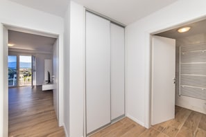 A modern interior with a sliding door, a view of the outdoors, and a wooden floor. - Altiora Prestige Residence 301 (Gradac)