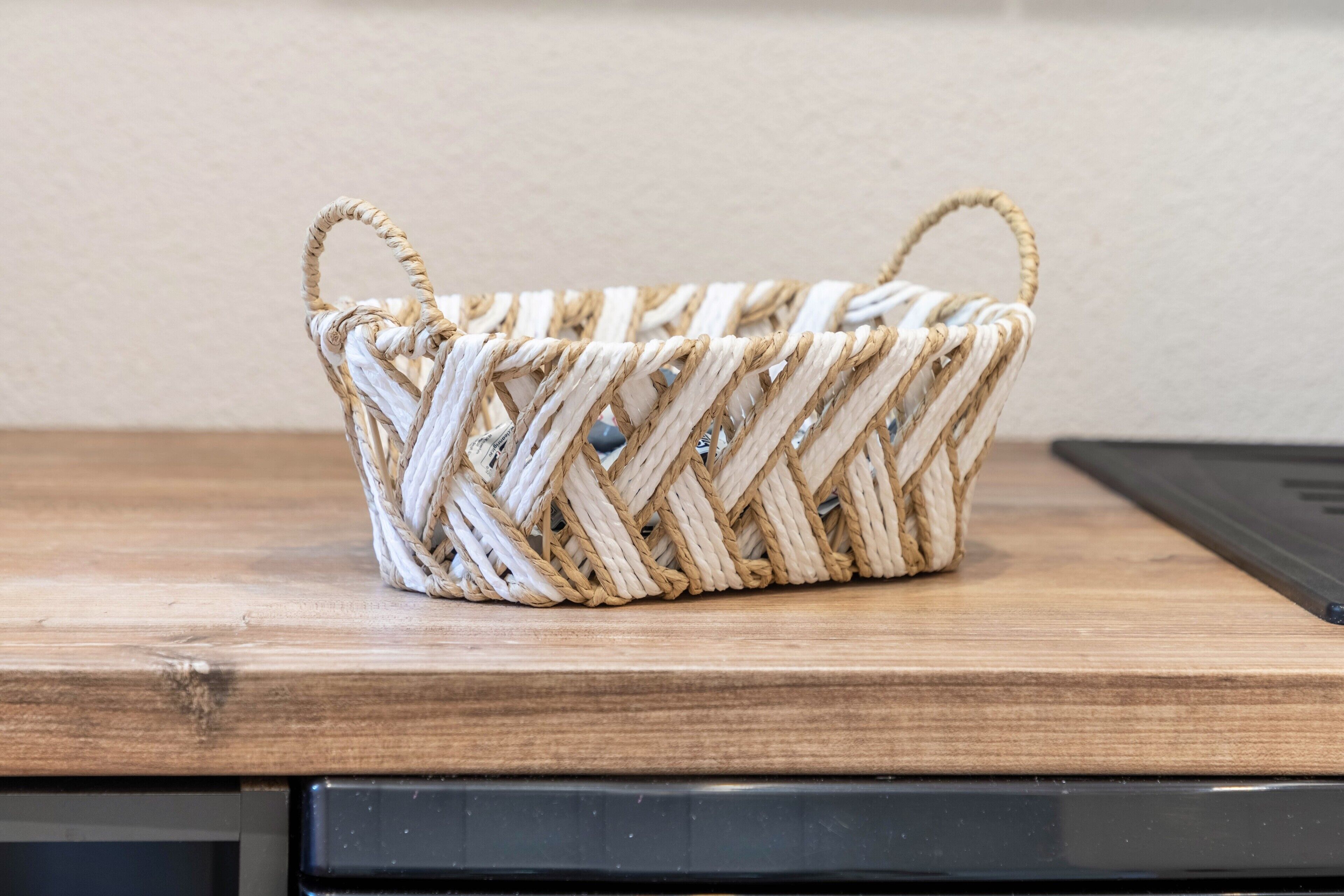 A woven basket on a wooden surface.