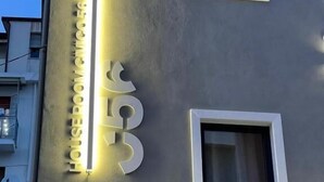 A modern building with a large illuminated sign reading 'HOTEL' and the number '056'.