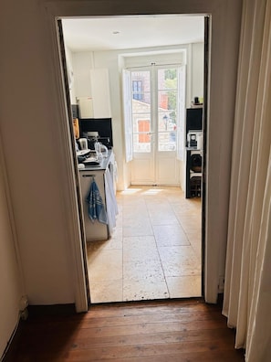 A narrow hallway leading to a kitchen with a view of the street. - Charming apartment in Sartène, South Corsica, terrace with panoramic view (Sartène)