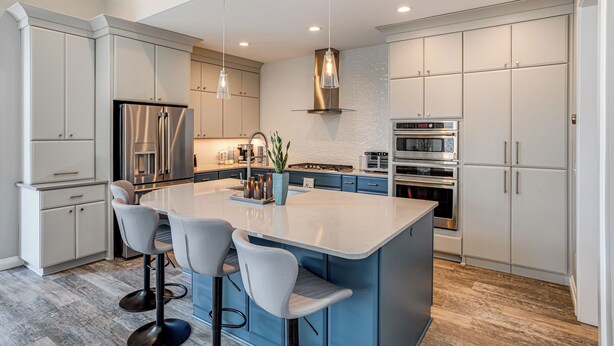 A modern kitchen with a large island, bar stools, stainless steel appliances, and pendant lighting. - Greenwood Group Retreat w/ Large Private Dock! (Greenwood)