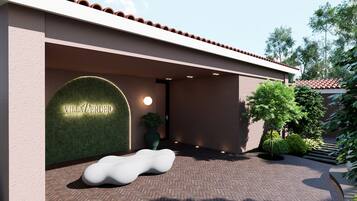 A modern building entrance with a sign reading 'Villa Verdejo Sitios.'