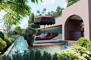 Un área de piscina con sillones de descanso, una sombrilla grande y una planta en maceta.