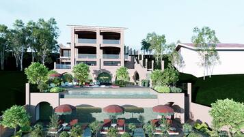 A modern hotel with a pool, outdoor seating, and lush landscaping.