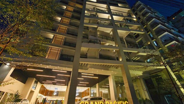 A multi-story hotel with a modern design, featuring balconies and a well-lit entrance. - Hotel Grand Pacific (Cox's Bazar)