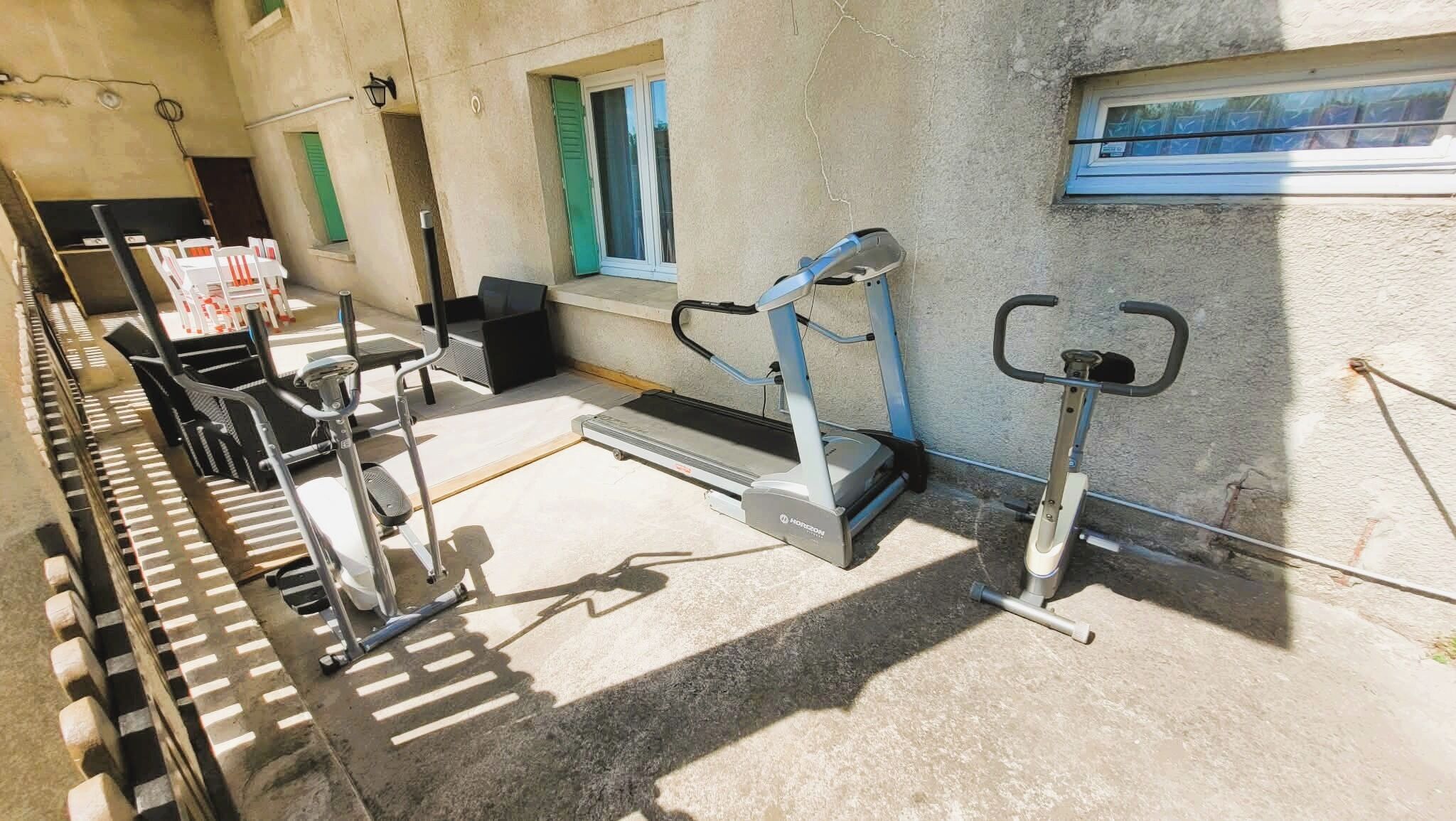 A gym with treadmills, stationary bikes, and weight machines.