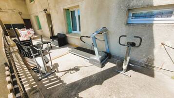 A gym with treadmills, stationary bikes, and weight machines.