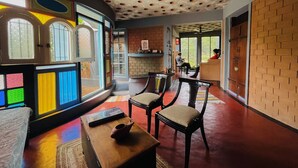 A room with a unique ceiling design, large windows, and a brick wall. - Dyavaaprthivi (Shoolagiri)