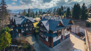 A residential area with multi-story houses featuring steeply pitched roofs and a mix of brick and wood exteriors.