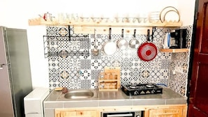 A kitchen with a built-in oven, a sink, and a stove. - Superbo Stay (Taghazout)