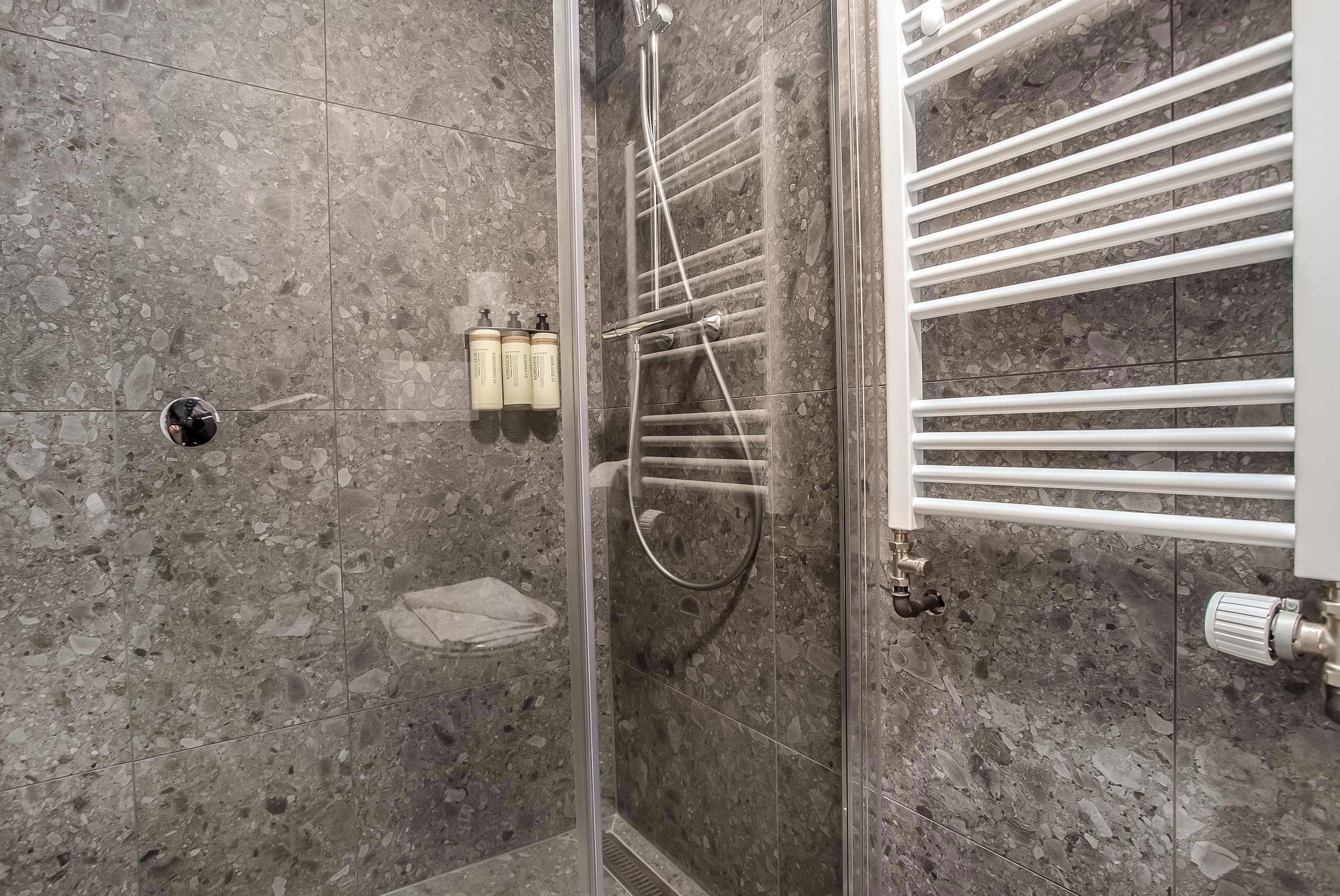 Shower, hair dryer, towels, shampoo