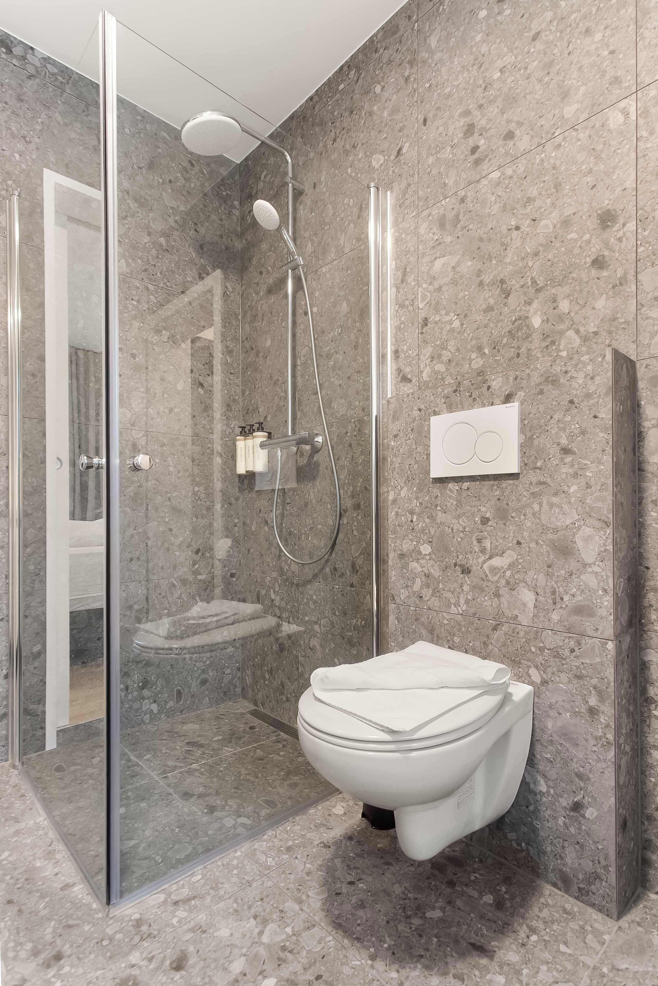 Shower, hair dryer, towels, shampoo