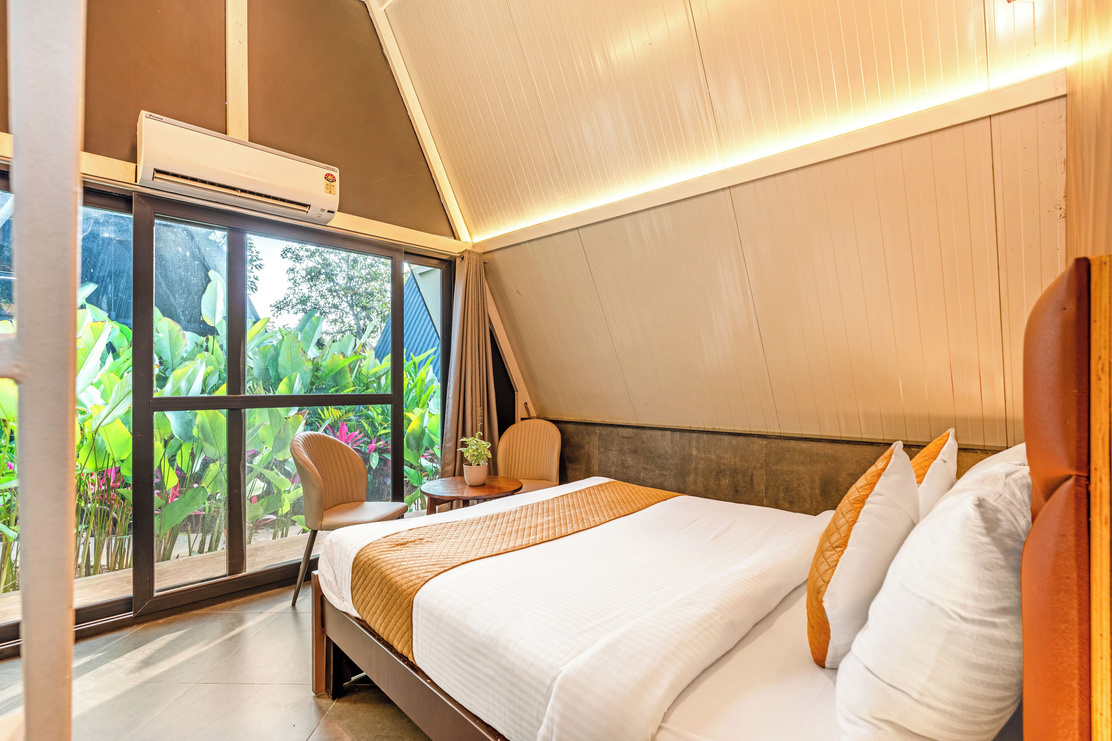 A modern bedroom with a large bed, a window, and a ceiling fan.
