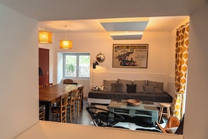 A cozy living area with a sofa, coffee table, and dining table.