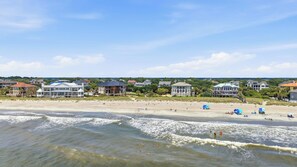 A beachfront property with multiple houses, a sandy beach, and the ocean. - Blue Heron Hideaway Beautiful Home in DeBordieu (Georgetown)