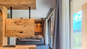 Un intérieur moderne avec un mur d’accent en bois, un canapé gris et une table à manger.