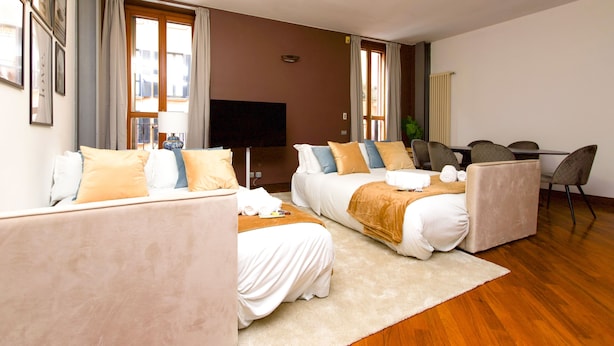 A hotel room with two beds, a TV, a desk, and a chair. - "View Brera Penthouse" Private Jacuzzi + Duomo 5 Min (Milano)