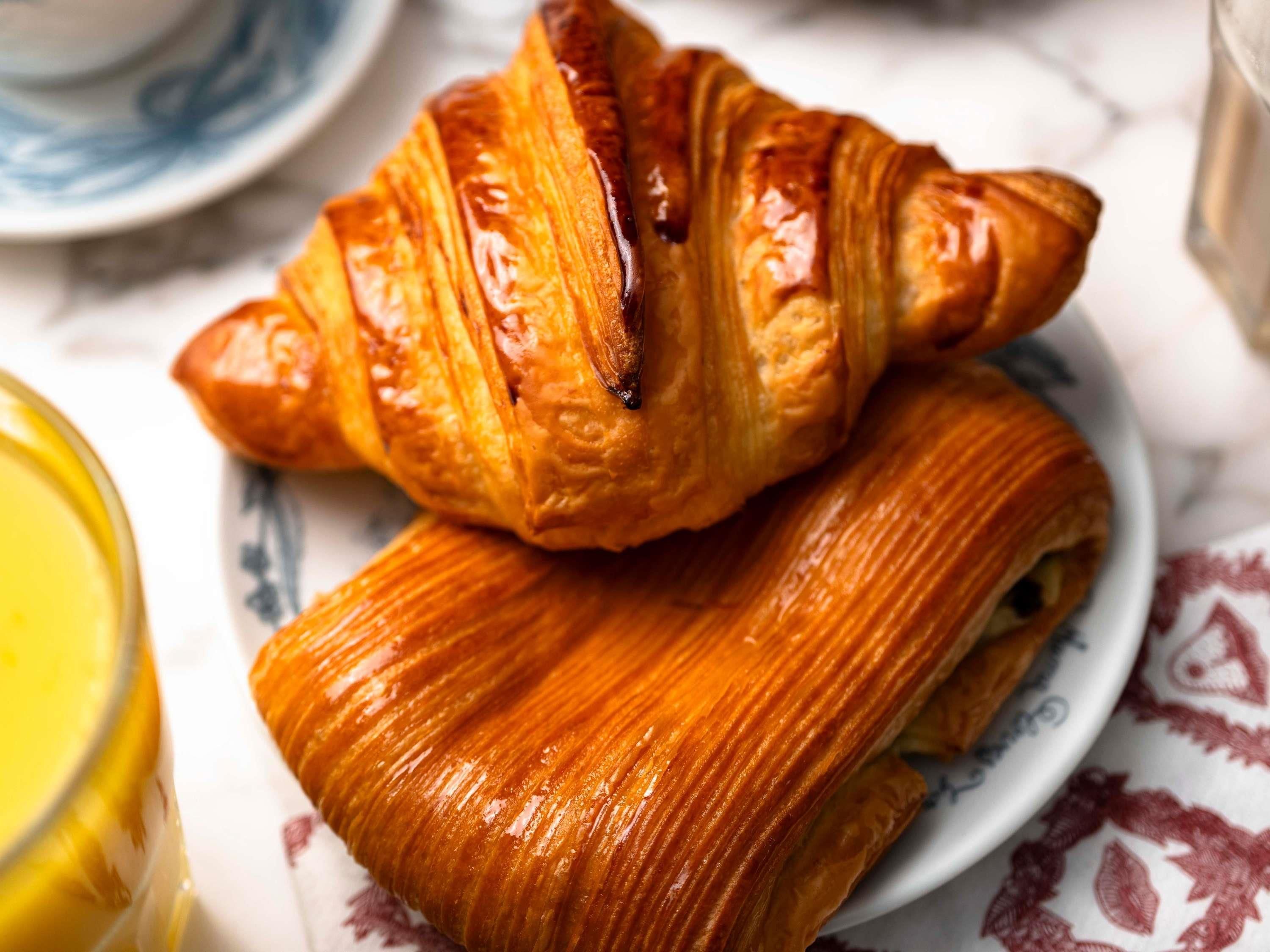 A croissant and a pastry on a plate.