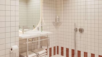 A modern bathroom with a white sink, a mirror, a towel rack, and a shower area.
