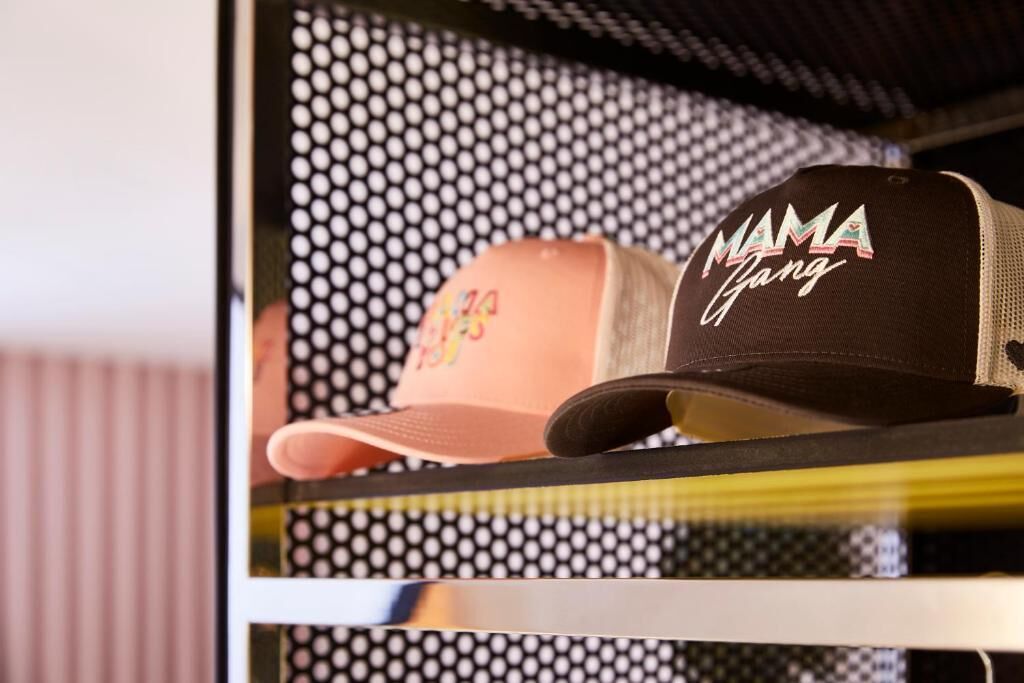 A black and brown cap with 'MAMA Gang' text on it.