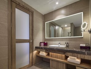A modern bathroom with a wooden door, a large mirror, a marble countertop, and built-in shelves. - Mercure Xi'An Daming Palace (Xi'an)