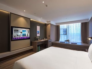 A modern hotel room with a large bed, a desk, a television, and a window with curtains. - Mercure Xi'An Daming Palace (Xi'an)