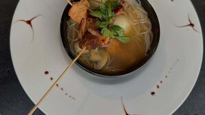 A bowl of soup with noodles and meat on a white plate. - Goshen Trust Hotel And Suites (Idanre)